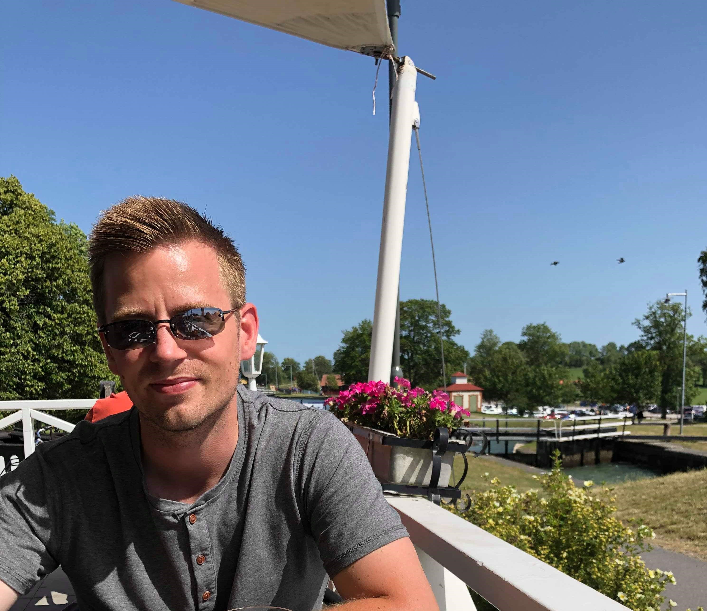 Alex smiling outdoors