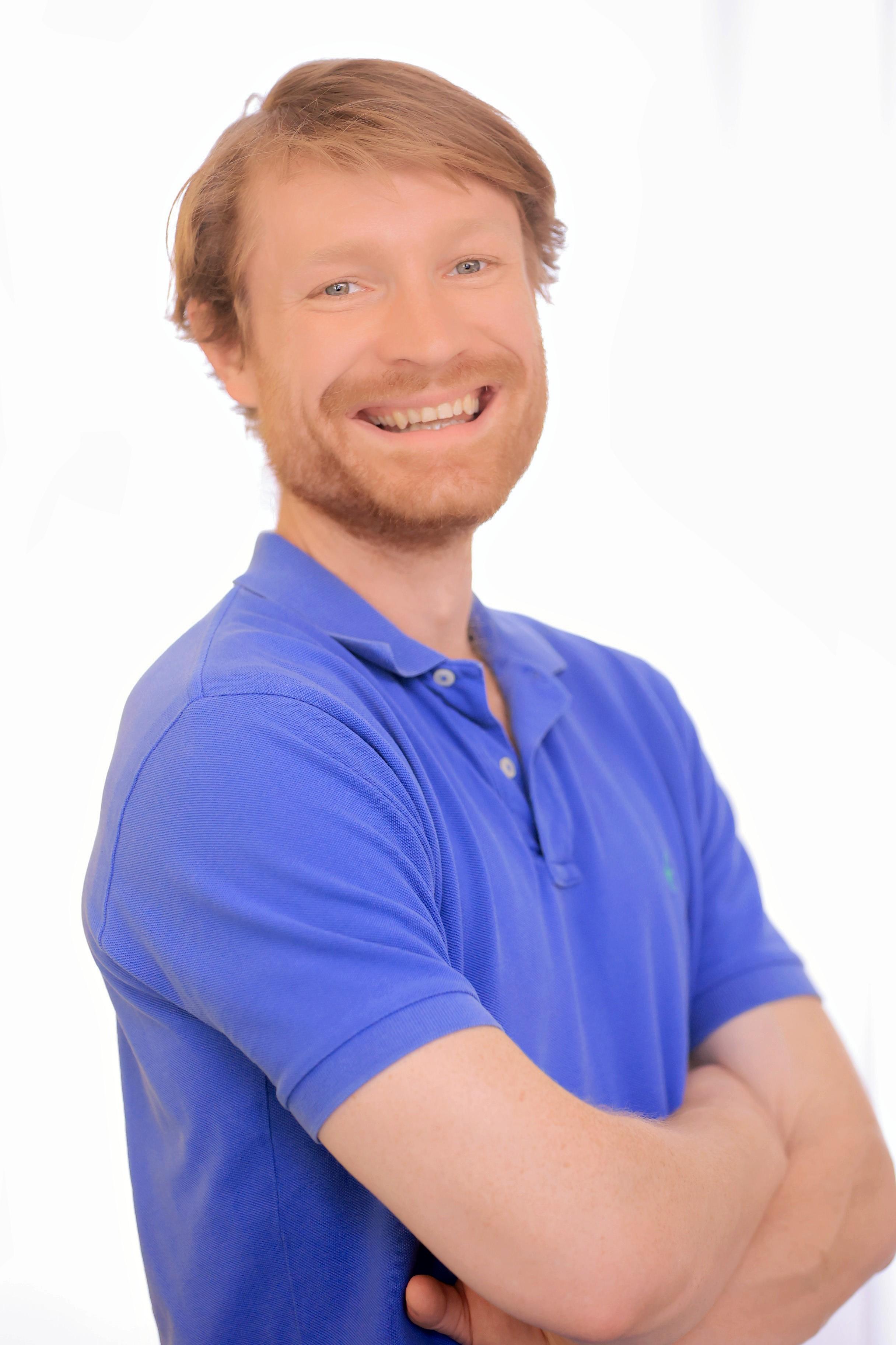 Harper smiling in a blue shirt